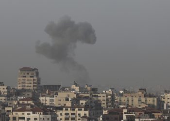 Smoke rises above buildings in Gaza City as Israel launched air strikes on the Palestinian enclave early on April 5, 2023. - After the announcement of the clashes at Al-Aqsa early on April 5, several rockets were fired from the northern Gaza Strip towards Israeli territory, according to AFP journalists and witnesses. The Israeli army said five rockets fired from the Gaza Strip were intercepted by the aerial defence system around Sderot in southern Israel, and that four others had fallen in uninhabited areas. Israeli fighter jets later struck two Hamas weapons manufacturing sites in the central Gaza Strip "in response" to the rocket fire, the army said. (Photo by Mohammed ABED / AFP)
